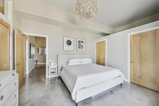 949 W Madison St Unit 601B, Chicago, IL 60607 - bedroom with finished concrete flooring, a chandelier, and baseboards