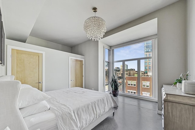 949 W Madison St Unit 601B, Chicago, IL 60607 - bedroom with finished concrete flooring, a chandelier, and a view of city