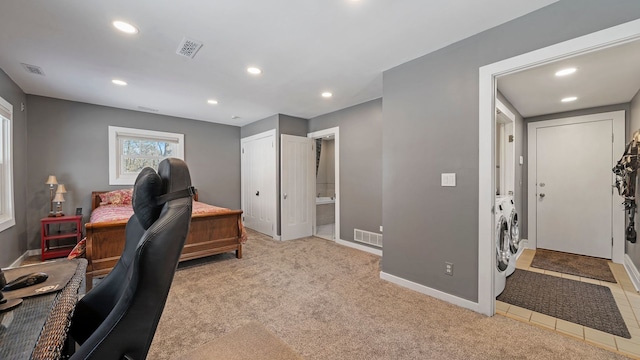 office space with washer and dryer and light colored carpet