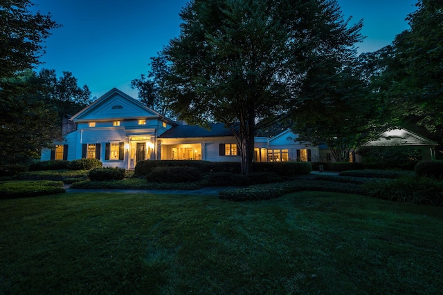 back house at dusk with a yard