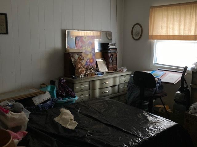 bedroom featuring wood walls