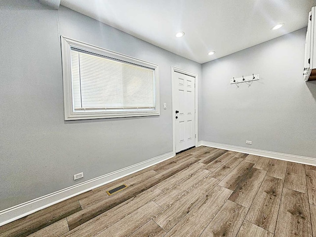 unfurnished room with light wood-type flooring