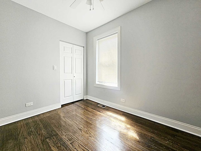 empty room featuring ceiling fan and dark hardwood / wood-style floors