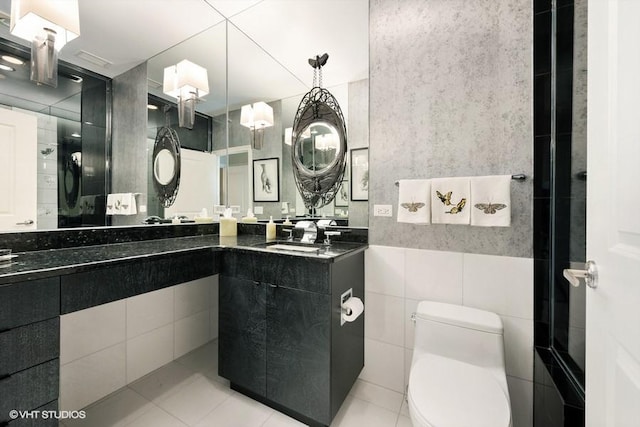 bathroom featuring toilet, tile walls, tile patterned floors, and vanity