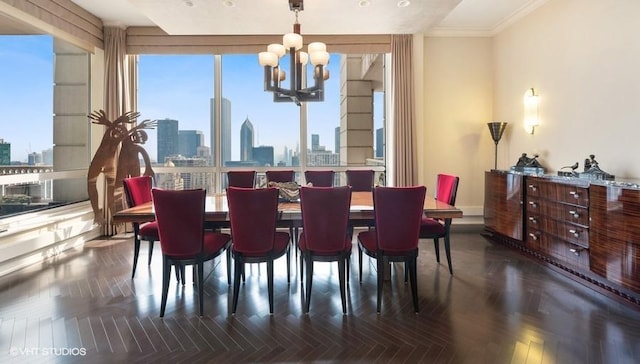 dining area with an inviting chandelier, crown molding, and dark parquet flooring