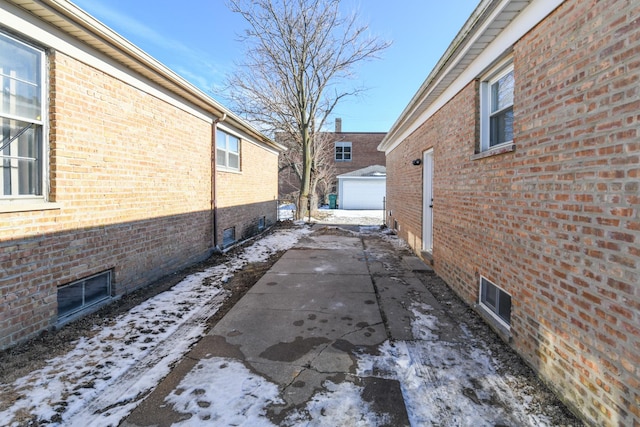 view of snowy exterior featuring a patio area