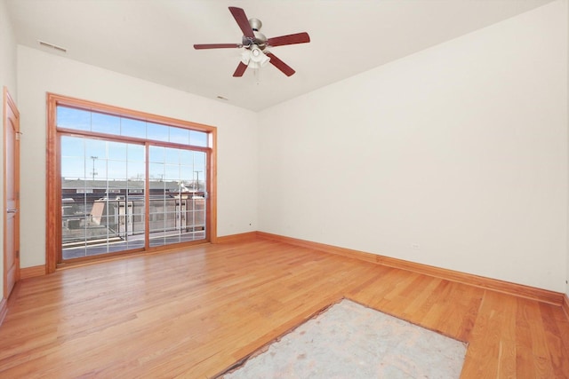 empty room featuring ceiling fan and hardwood / wood-style floors