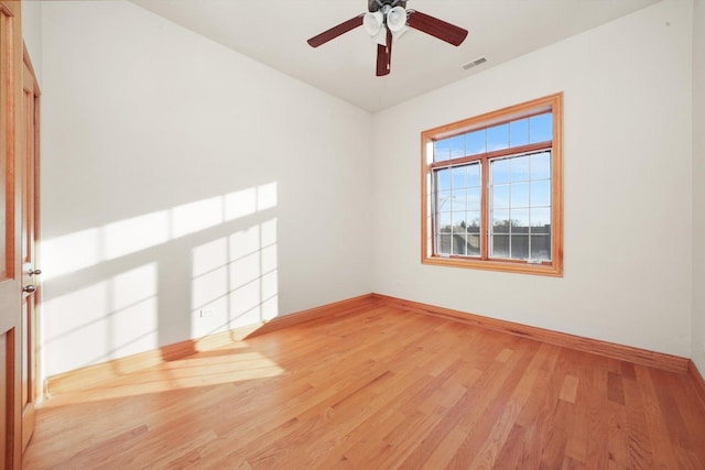 empty room featuring ceiling fan and hardwood / wood-style floors