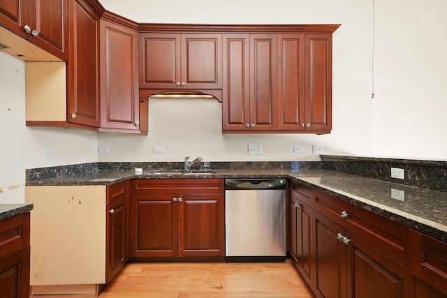 kitchen with light hardwood / wood-style floors, dishwasher, dark stone counters, and sink