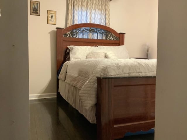 bedroom featuring dark hardwood / wood-style flooring