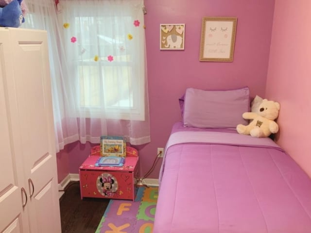 bedroom with wood-type flooring