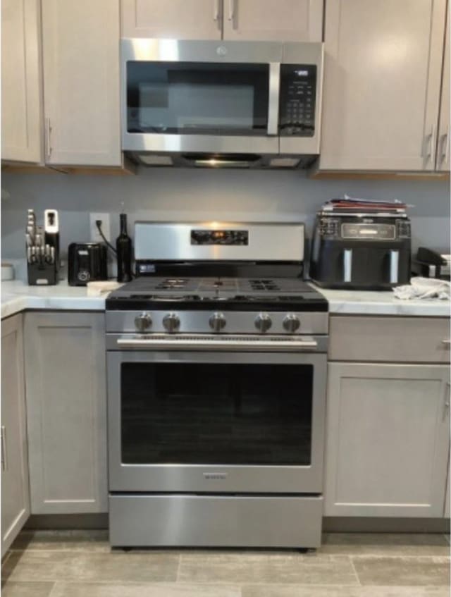 kitchen with appliances with stainless steel finishes and gray cabinets