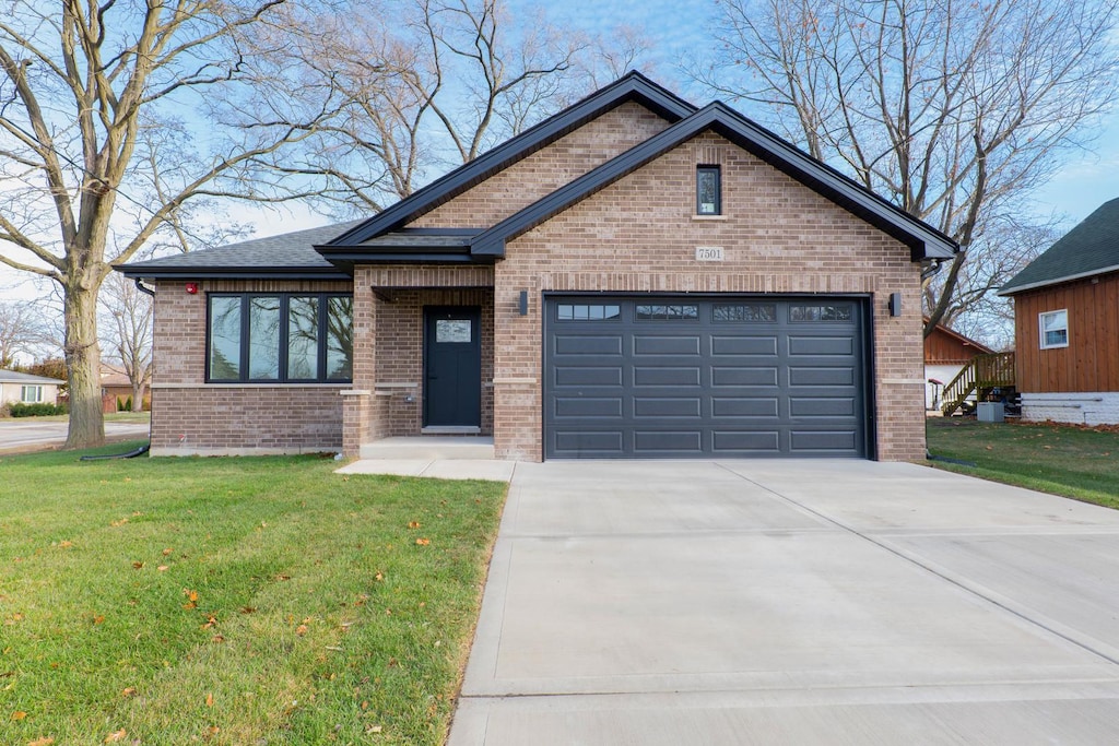 view of front of house with a garage and a front yard