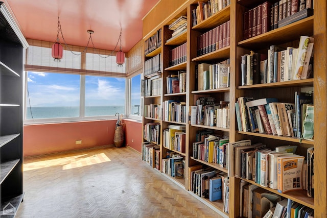 interior space featuring a water view and light parquet floors