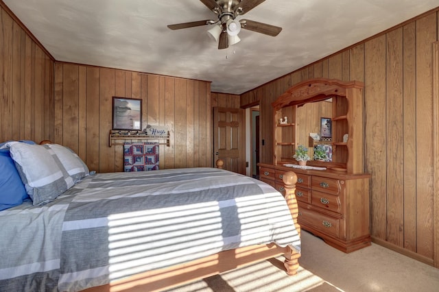 bedroom featuring light carpet, ceiling fan, and wood walls