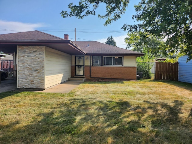 rear view of property with a lawn