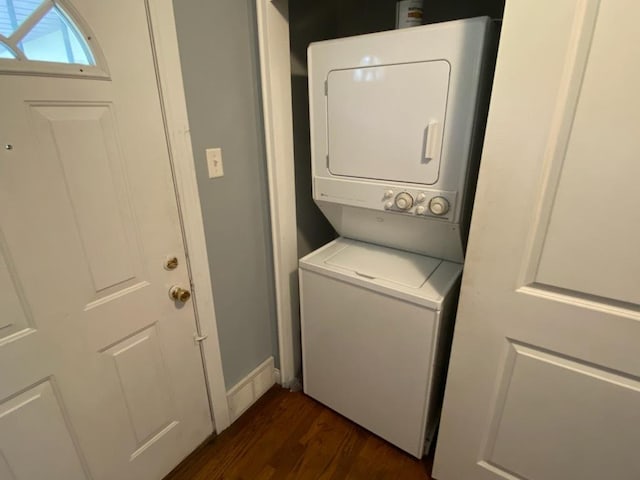 laundry area featuring dark hardwood / wood-style floors and stacked washing maching and dryer