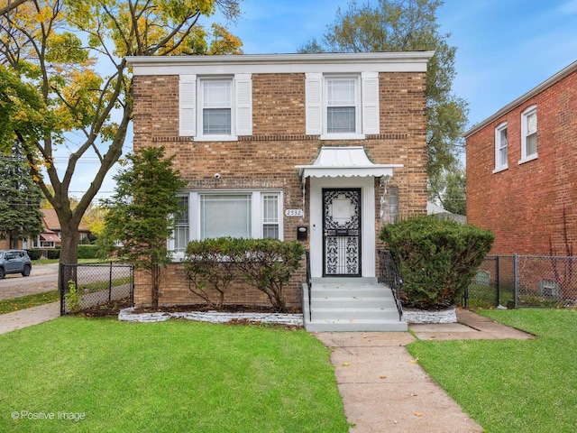 view of front of property with a front yard, fence, and brick siding