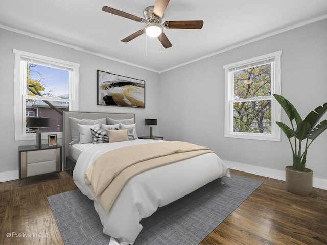 bedroom with multiple windows, wood finished floors, and ornamental molding