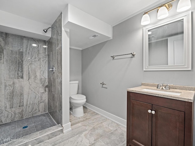 bathroom featuring visible vents, toilet, a shower stall, baseboards, and vanity