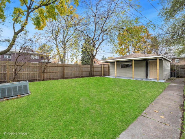 view of yard featuring an outdoor structure, central AC unit, and a fenced backyard