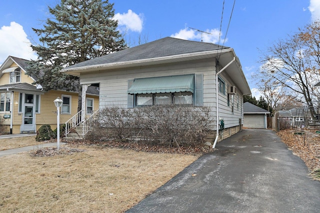 view of front of home with an outbuilding, a garage, and a front lawn