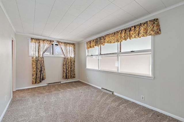 carpeted spare room featuring crown molding