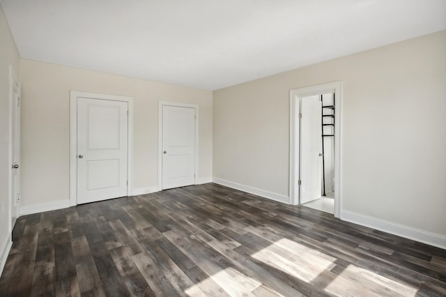 unfurnished bedroom featuring dark wood-type flooring