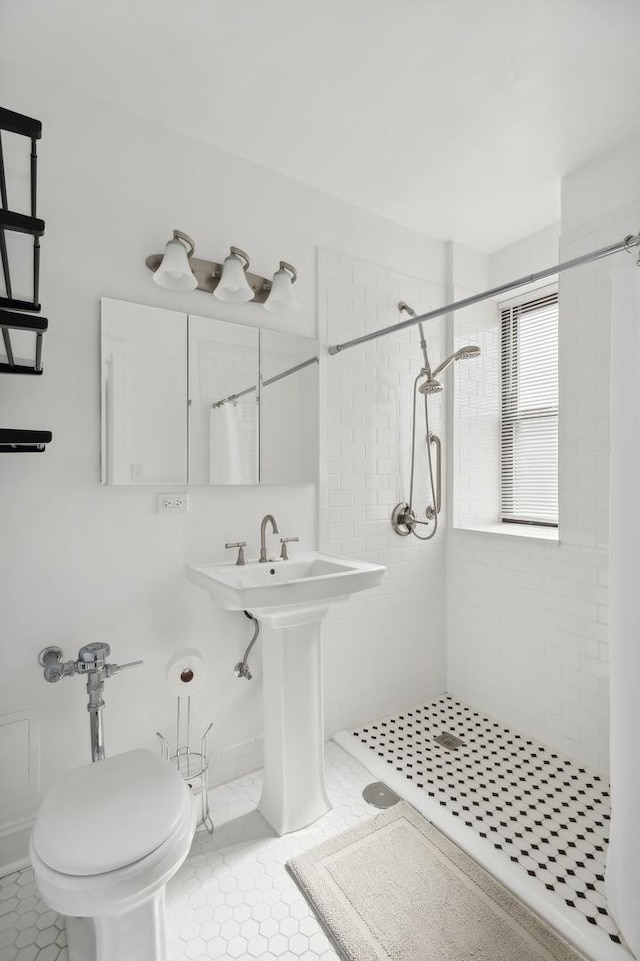 bathroom with sink, toilet, walk in shower, and tile patterned flooring