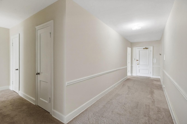 hall with light colored carpet