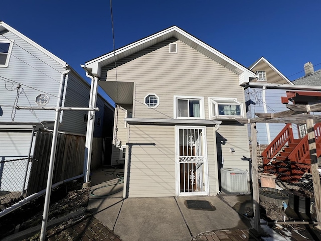 back of property featuring cooling unit and a patio