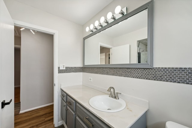 bathroom featuring hardwood / wood-style flooring, toilet, and vanity