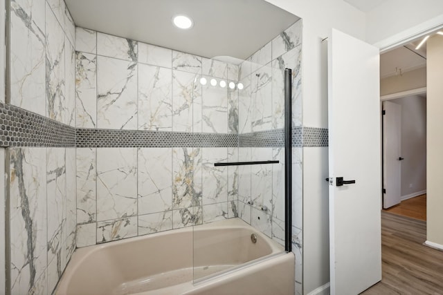 bathroom featuring tiled shower / bath combo and wood-type flooring