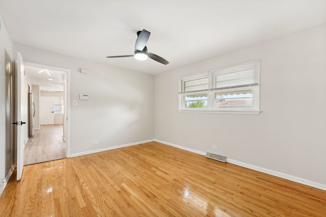 spare room with ceiling fan and light hardwood / wood-style flooring