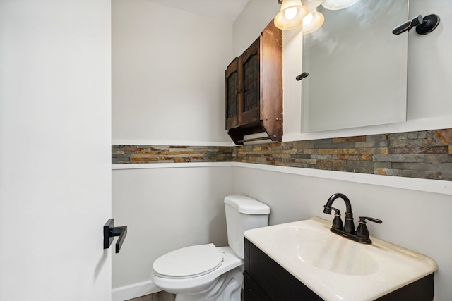 bathroom featuring toilet and vanity