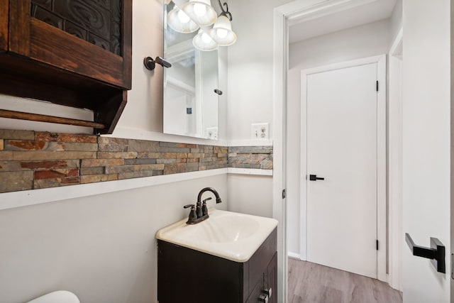 bathroom featuring hardwood / wood-style flooring and vanity