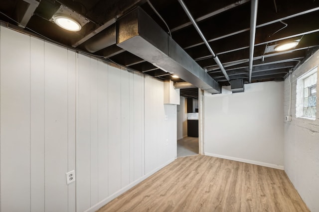 basement with hardwood / wood-style floors