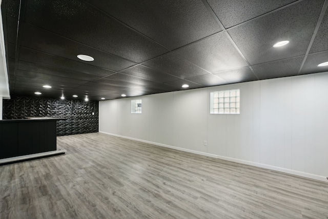 basement with hardwood / wood-style floors