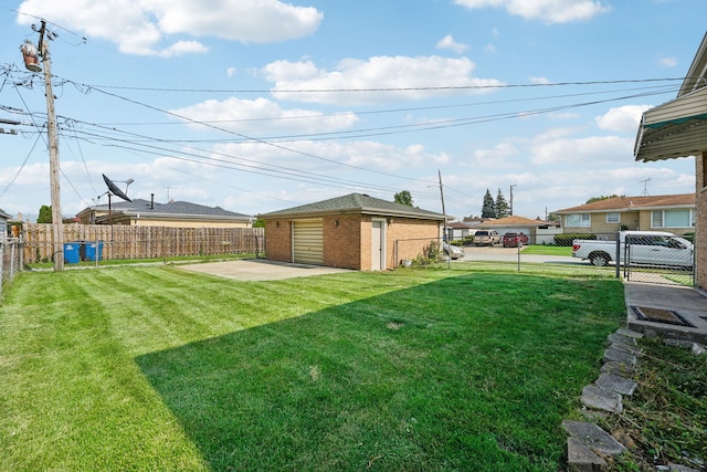 view of yard with an outbuilding, a patio area, and a garage