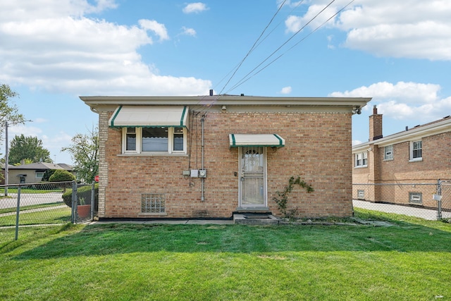 back of property featuring a yard