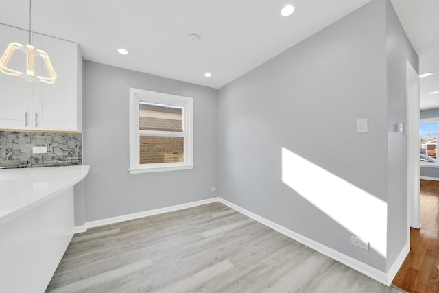 unfurnished dining area with light hardwood / wood-style floors