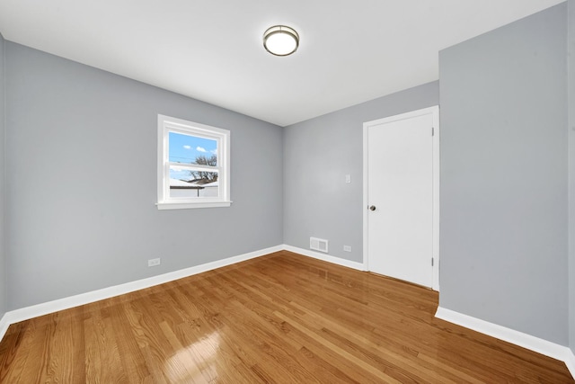 unfurnished room with wood-type flooring