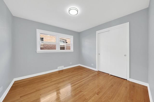 unfurnished bedroom featuring a closet and light hardwood / wood-style flooring