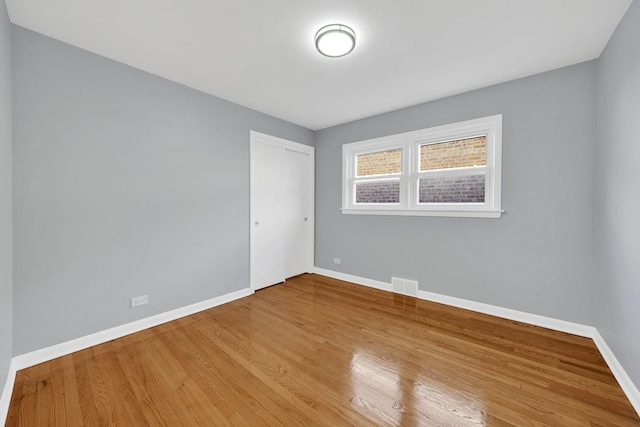 empty room with hardwood / wood-style floors