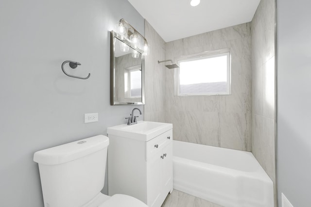 full bathroom featuring toilet, vanity, and tiled shower / bath