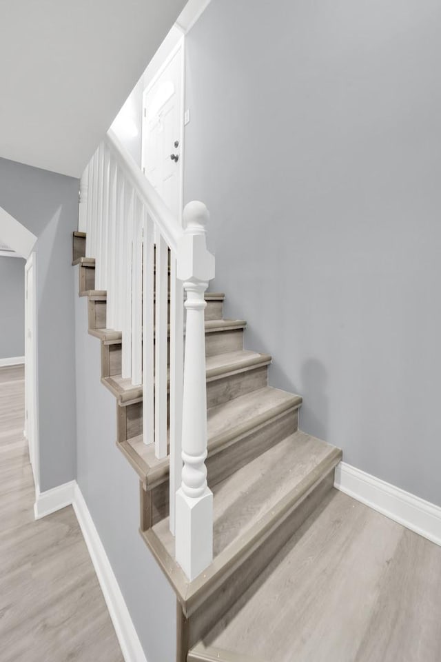 stairs with hardwood / wood-style flooring