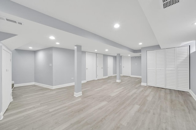 basement with light hardwood / wood-style floors