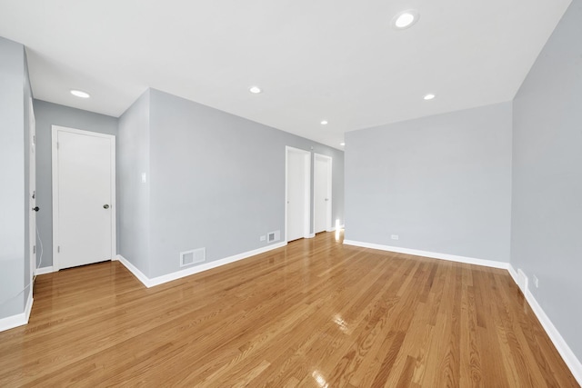 unfurnished room with light wood-type flooring