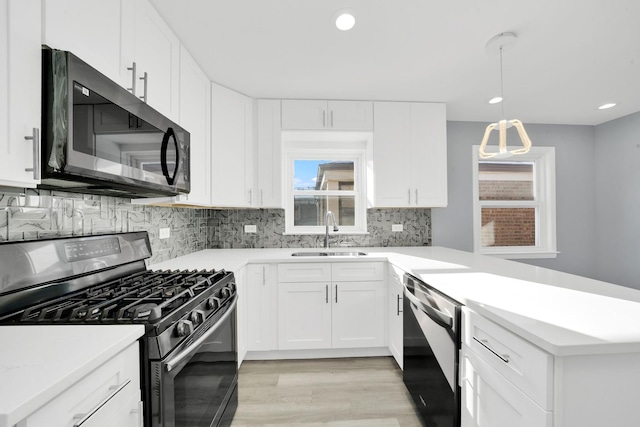 kitchen with white cabinets, dishwashing machine, sink, and range with gas stovetop