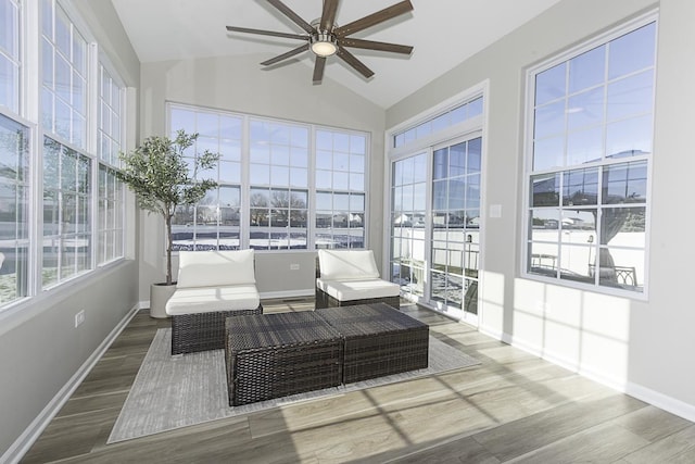 sunroom featuring ceiling fan, vaulted ceiling, and plenty of natural light